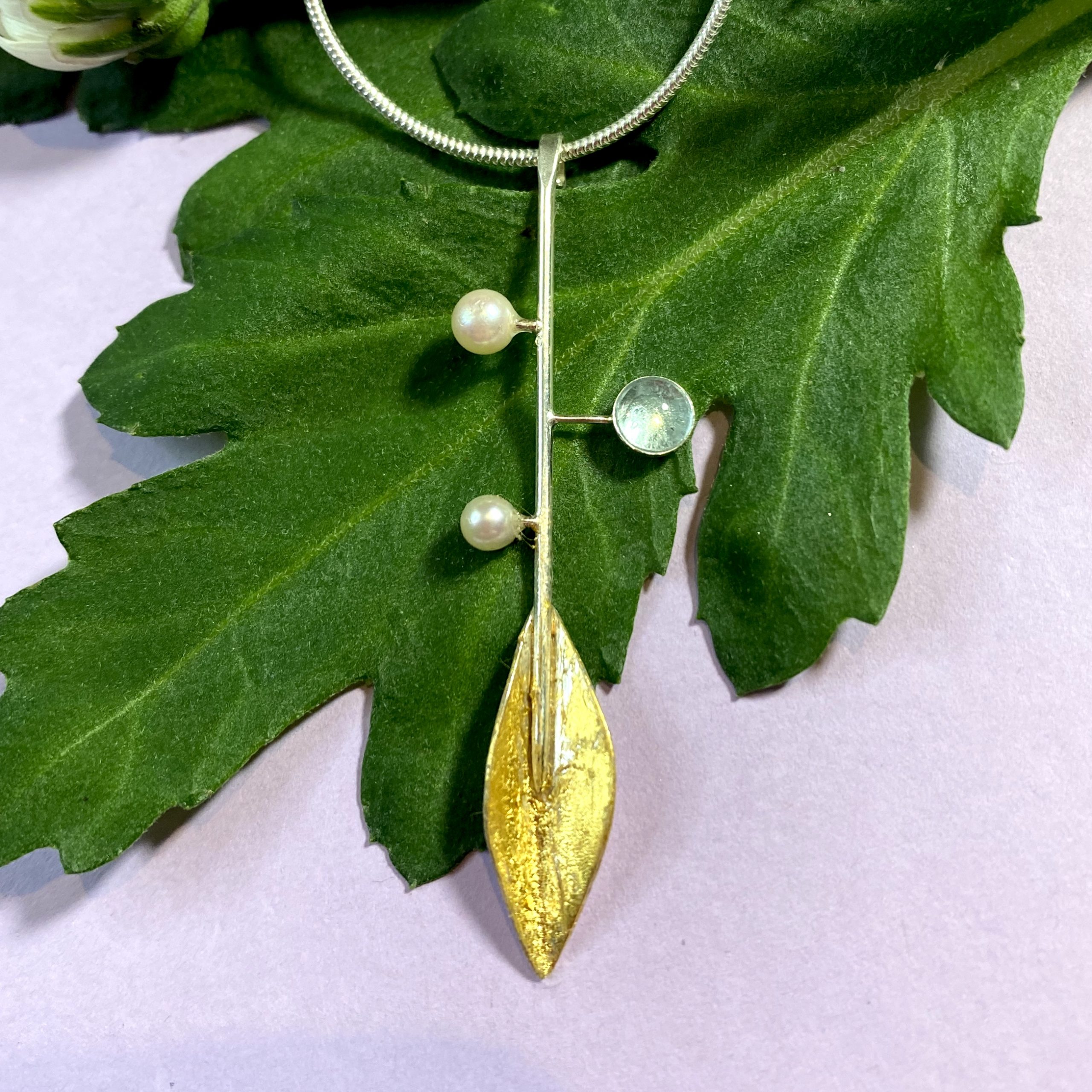 Botanics stem pendant with topaz & pearl