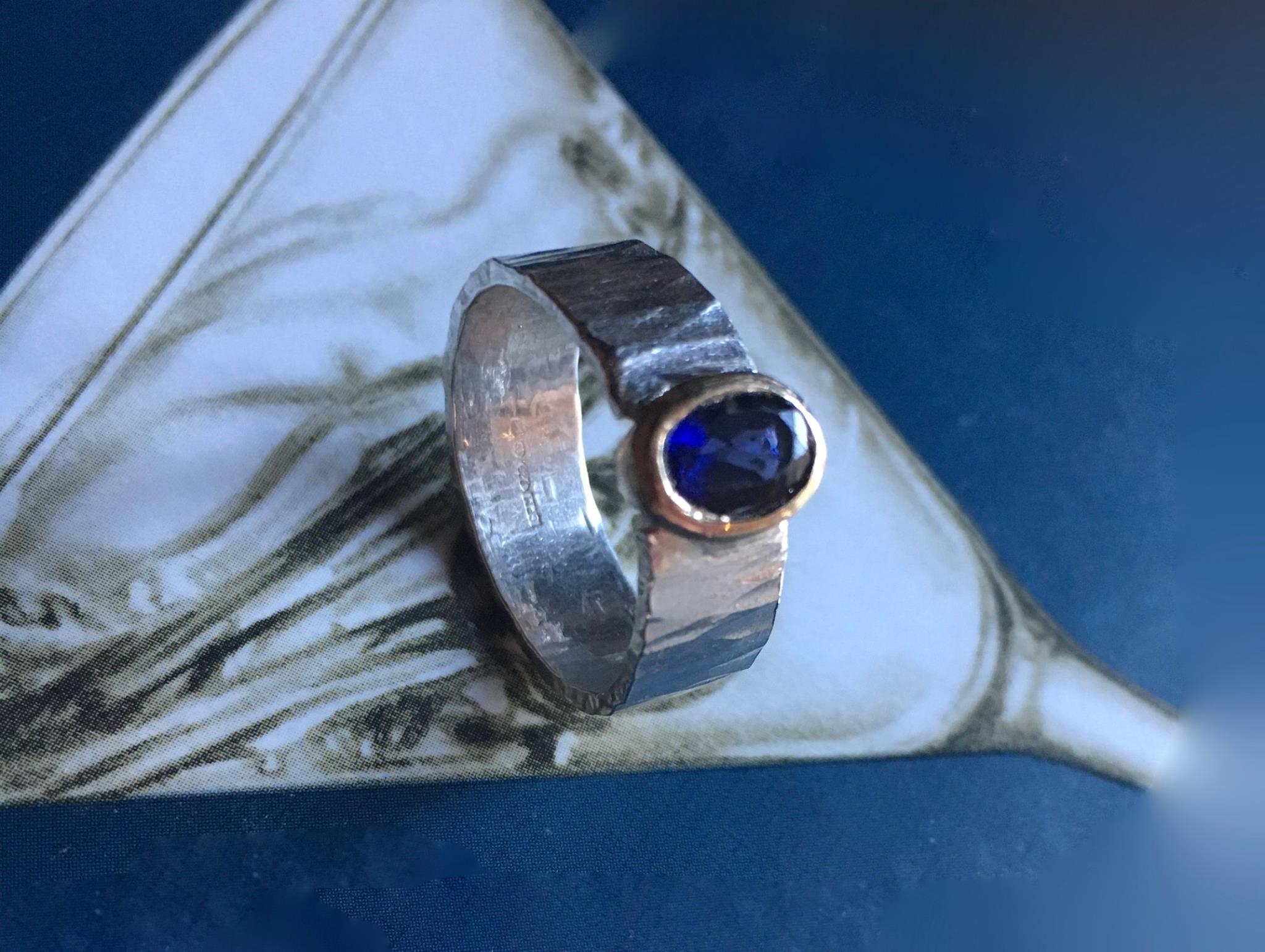 Hammered silver ring with iolite in gold